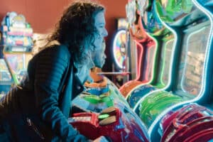 Couple playing a motor arcade game