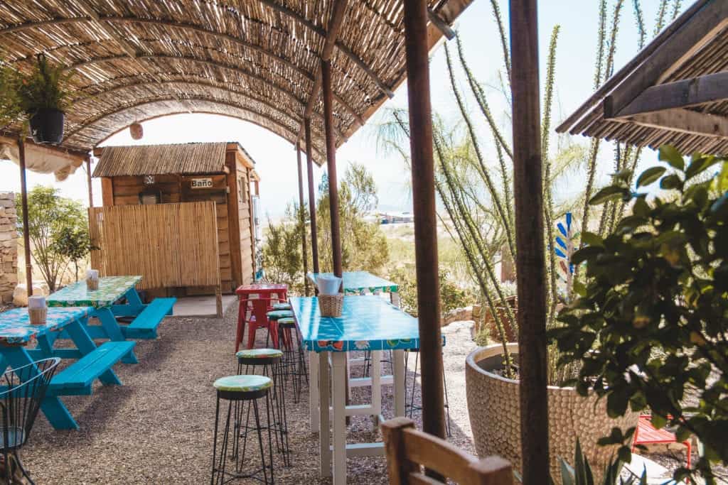 a patio with tables and chairs