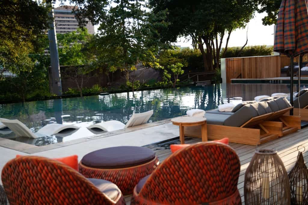  A refreshing pool surrounded by lounge chairs and umbrellas