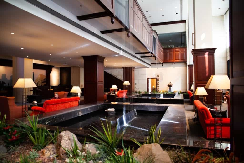 Hotel lobby featuring a fountain and red couches