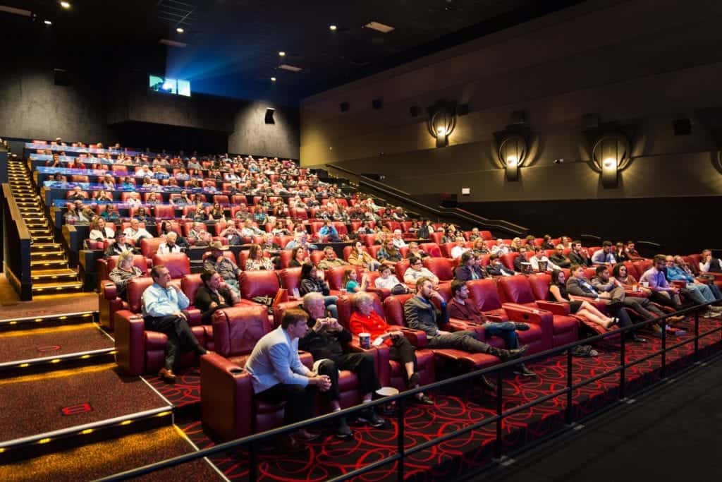 A large crowd of people sitting in a movie theater