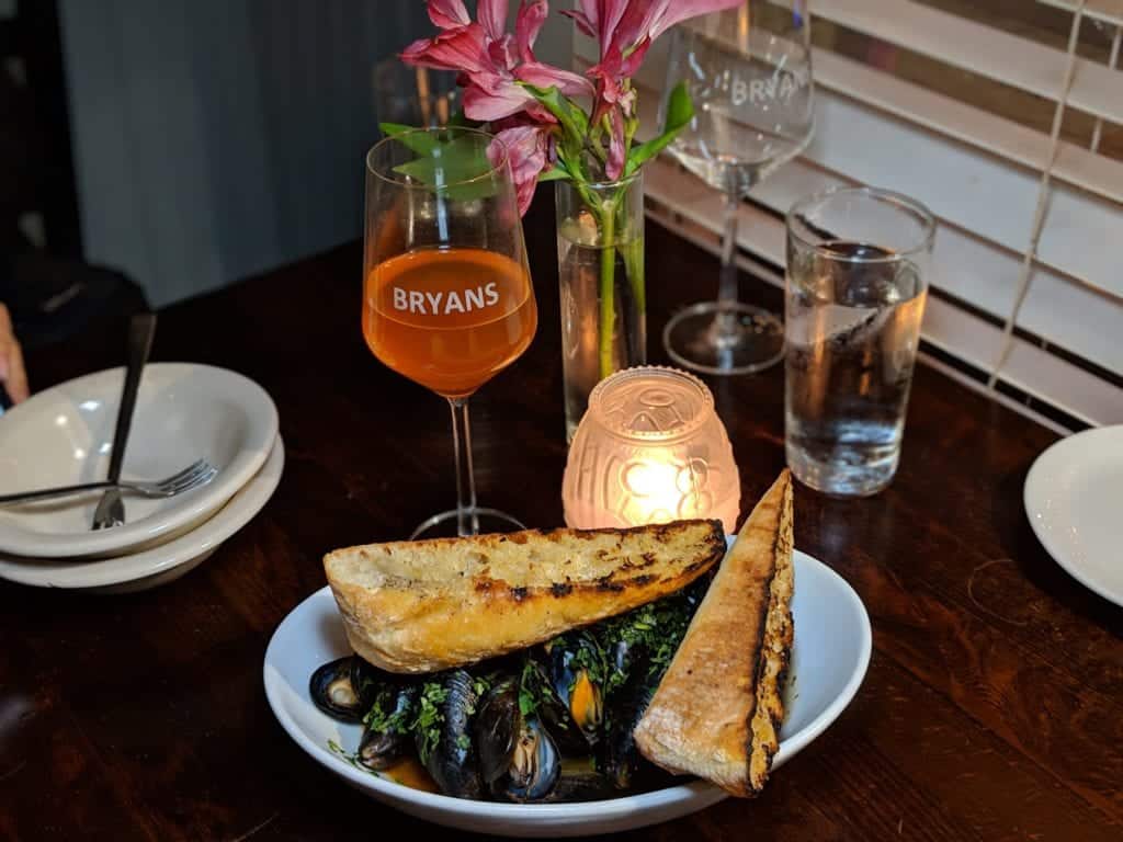 a plate of food and wine glasses on a table