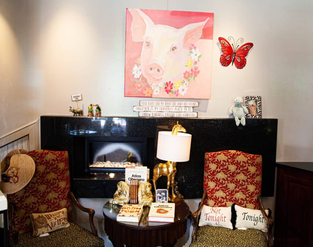 chairs, table, butterfly and painting of a pig