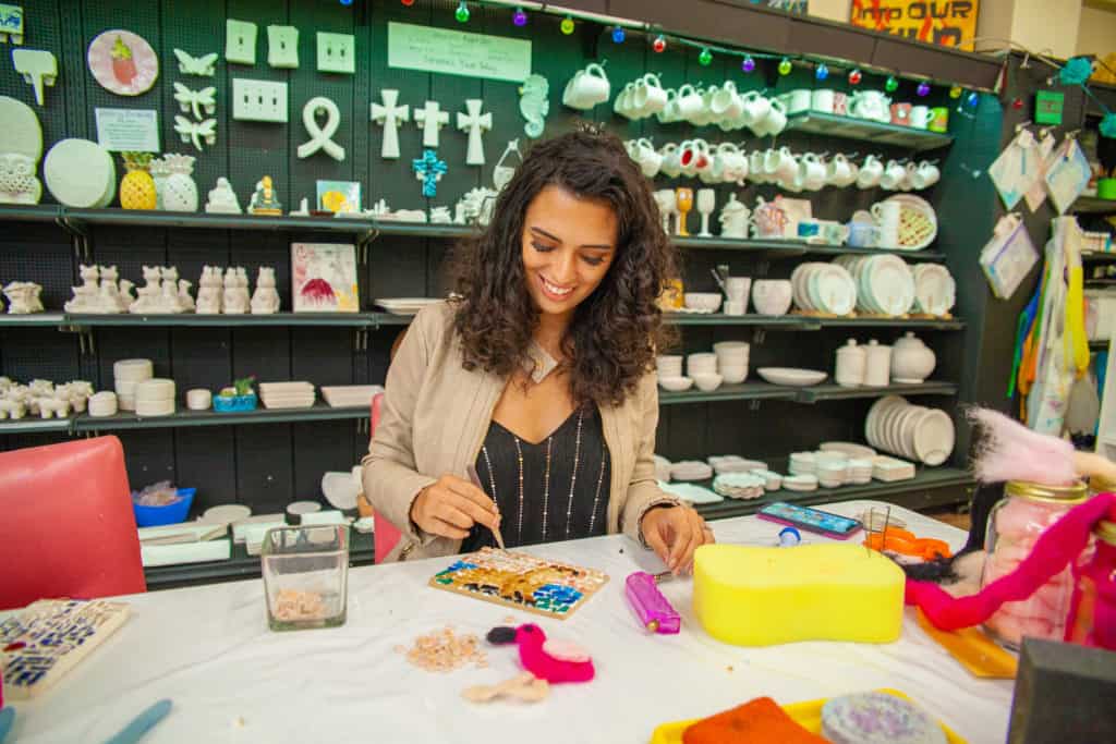 a person painting on a table