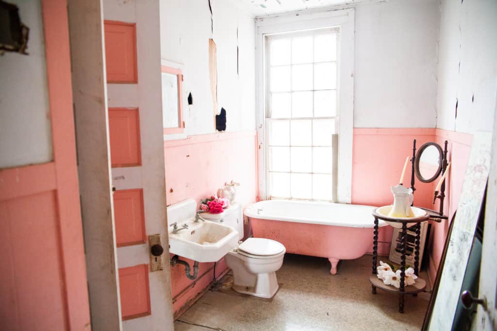 a bathroom with pink walls and pink walls