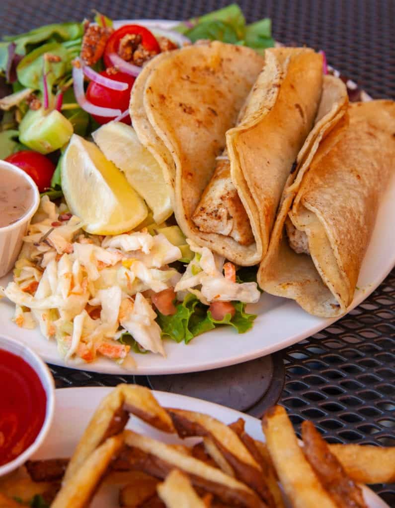 a plate of food with a side of salad and french fries