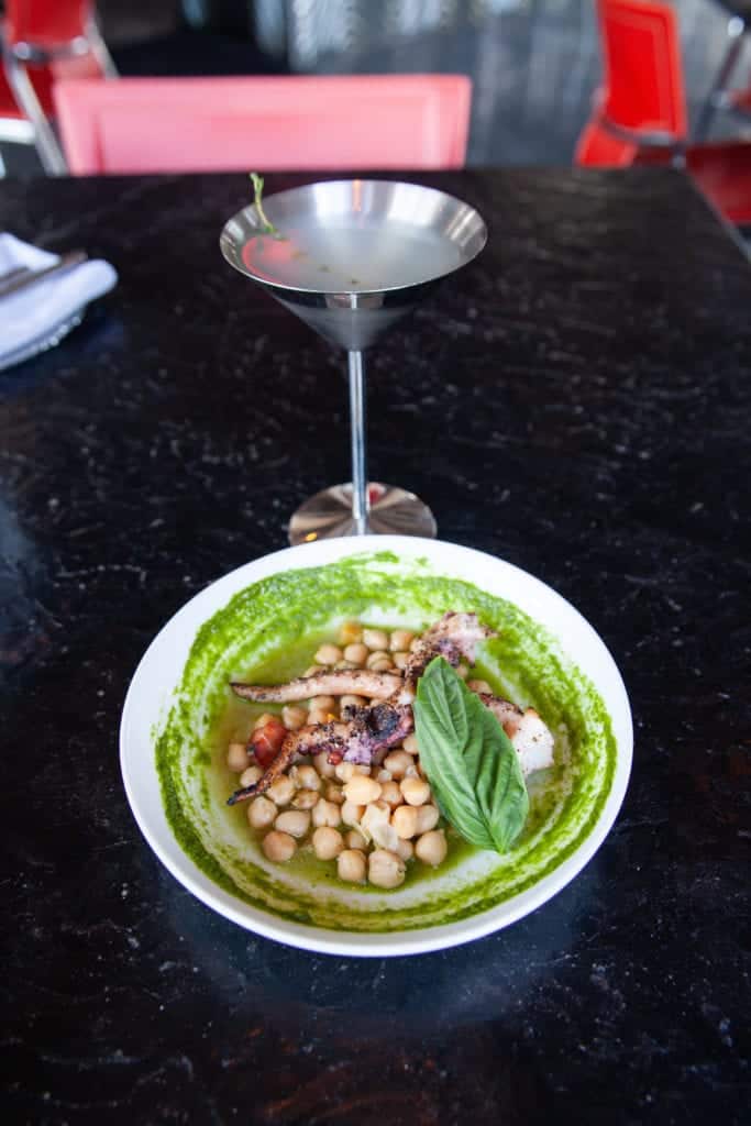 a bowl of food next to a martini glass