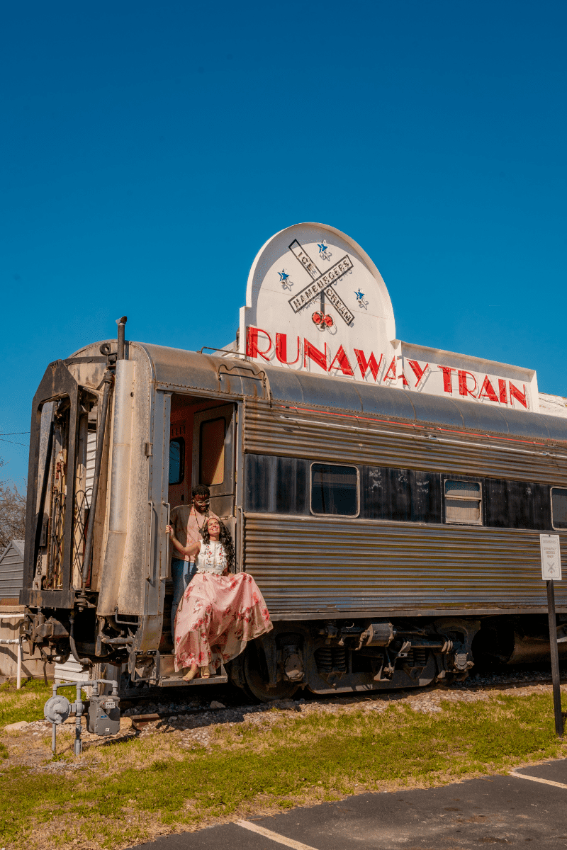 Couples posing at the entrance of Train Cafe