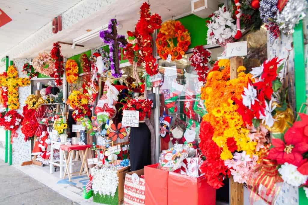 a storefront with flowers and decorations