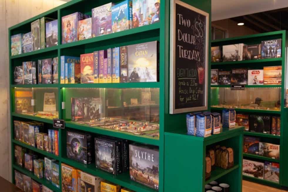 Green bookshelf displaying various board games