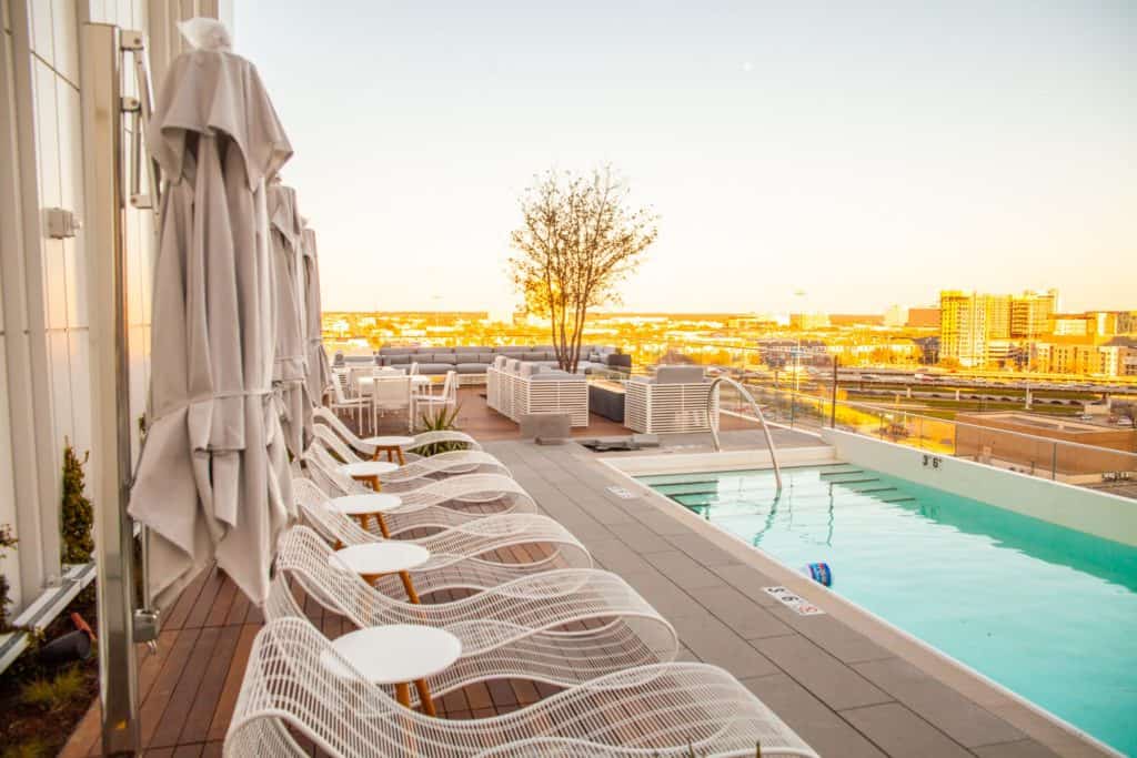Rooftop pool with lounge chairs  at Hall Arts Hotel Dallas