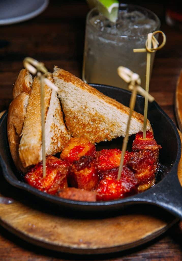 a pan of food with a couple pieces of bread