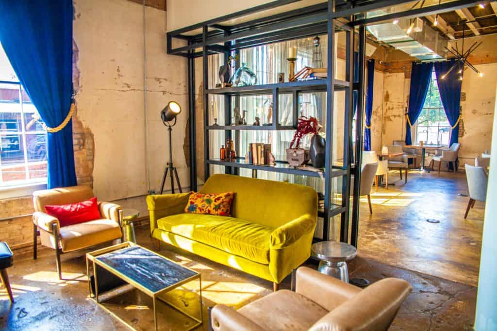 A living room featuring a bright yellow couch