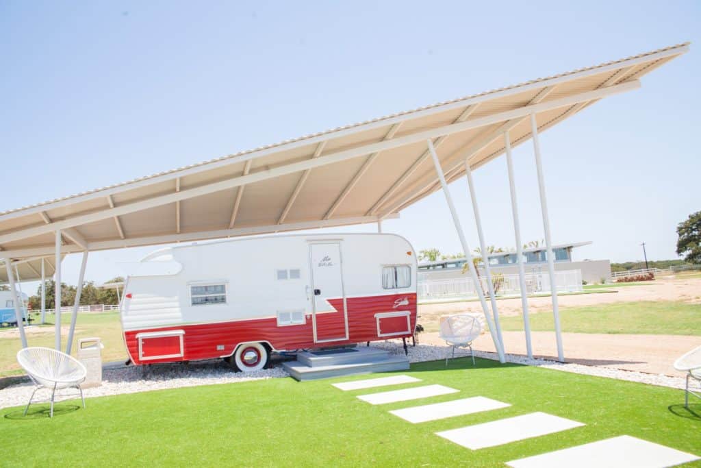 a red trailer under a roof