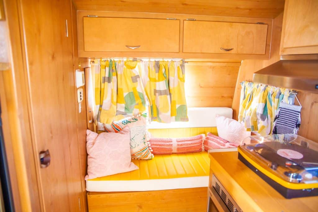 a kitchen with a yellow and white pillow