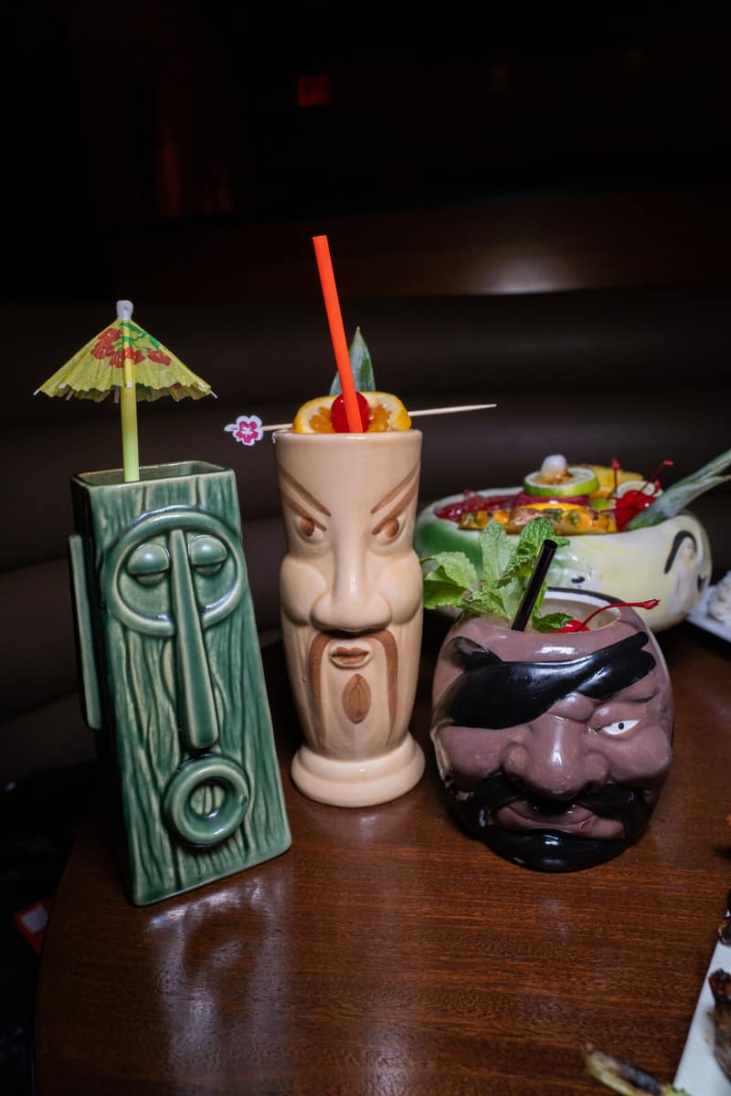 Three cocktails next to each other on a table: One Eyed Pirate, served in a pirate head and made with spiced rum; Dr Funk, served in a Fu Manchu glass, and 