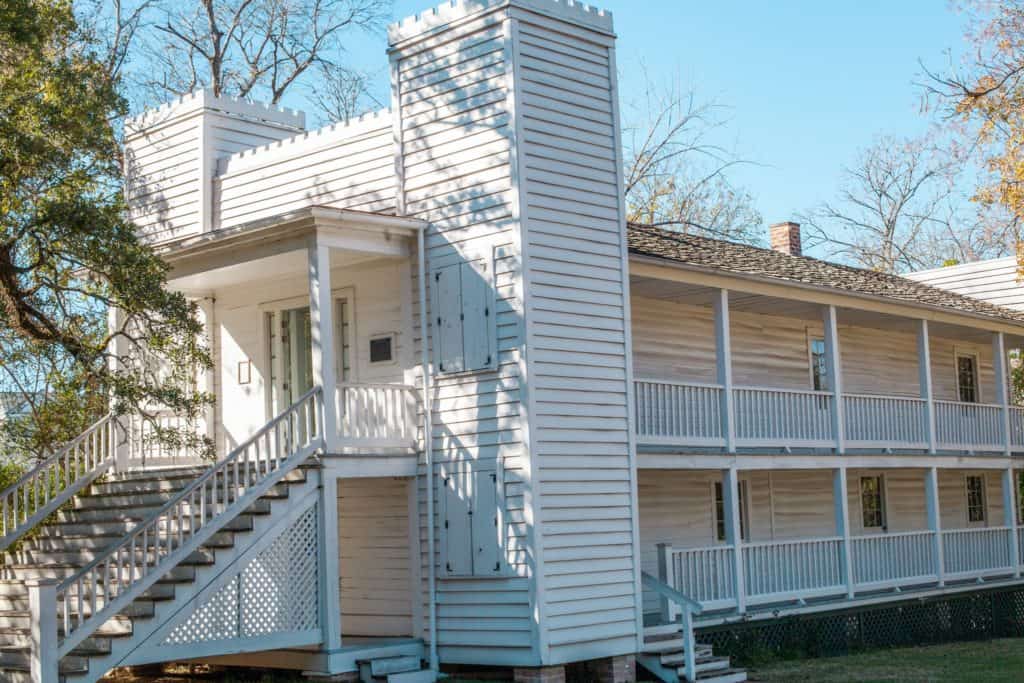 a white house with a porch and stairs