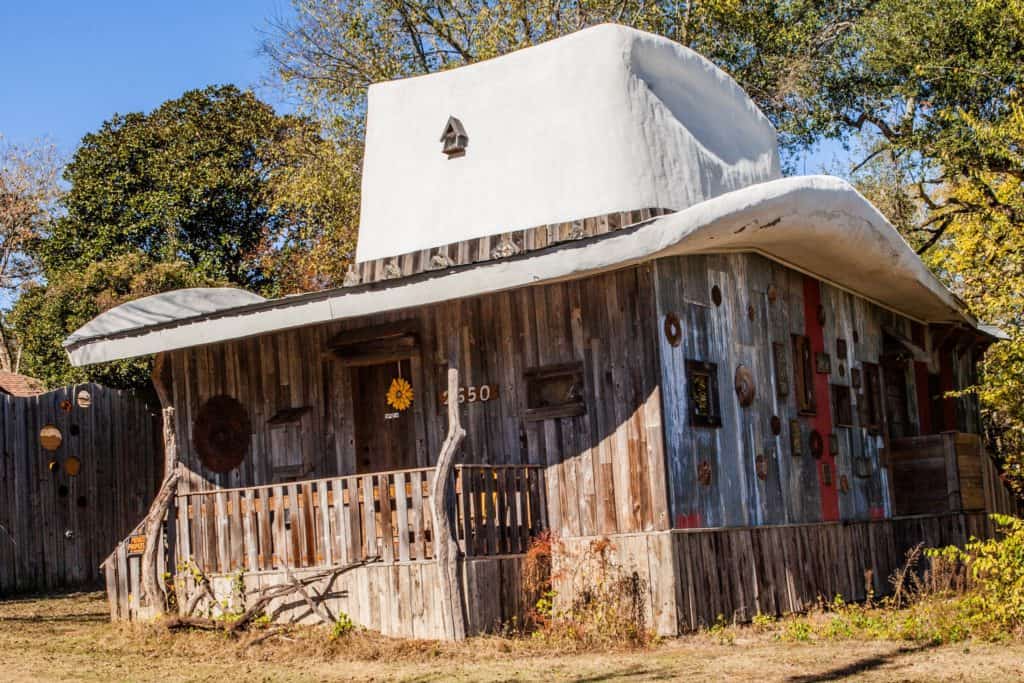 a wooden house with a cowchild hat