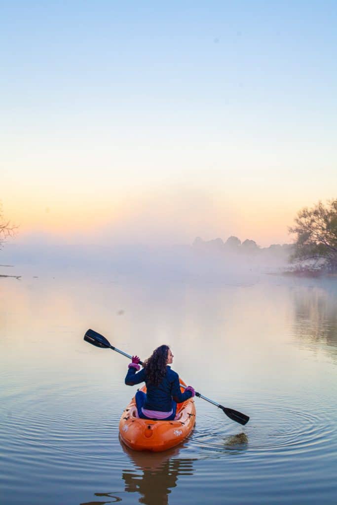 a person in a canoe on a lake