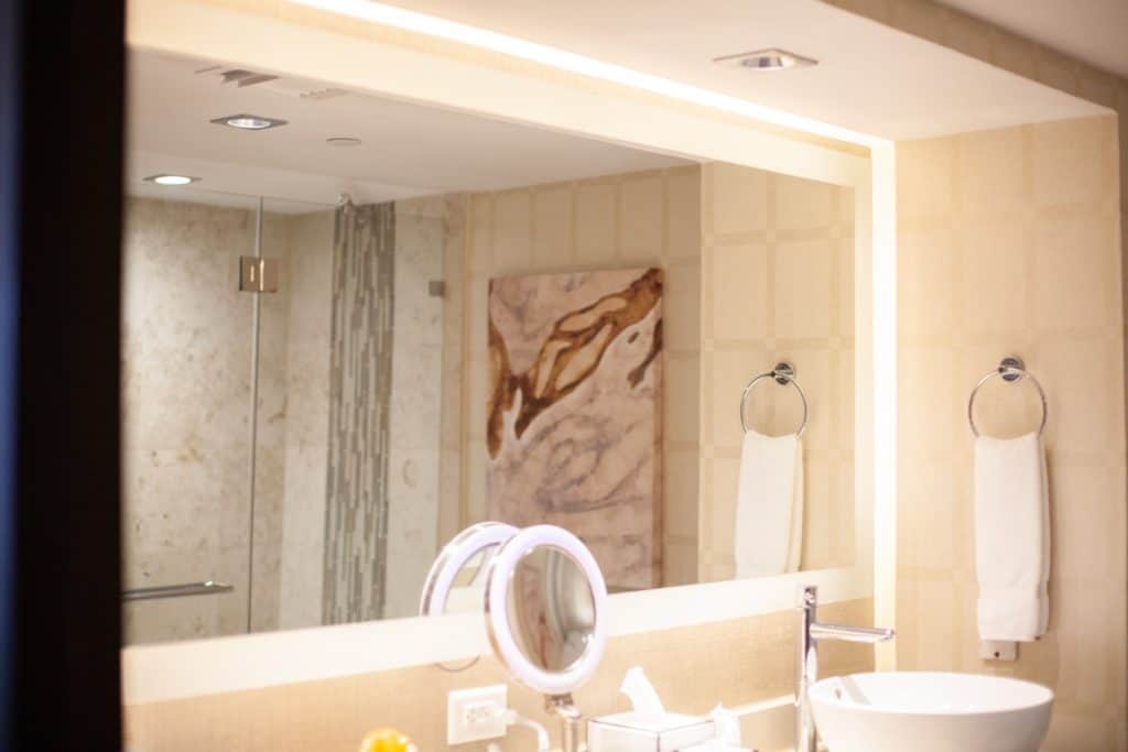 A bathroom featuring a sink, mirror, and a shower