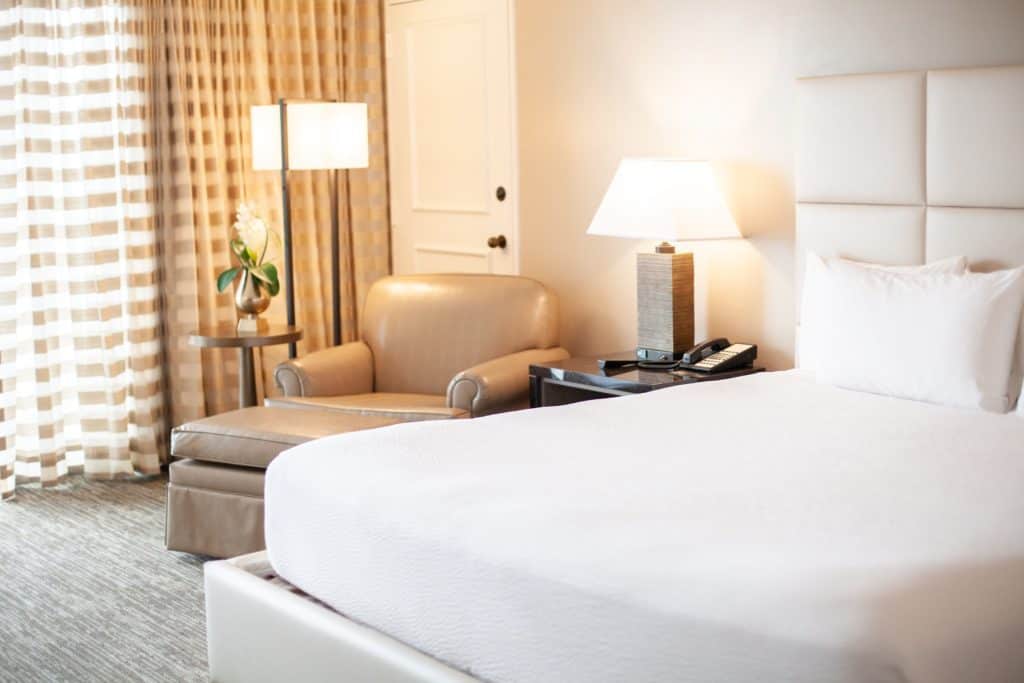 Galveston Hotel room featuring a king bed and a comfortable chair