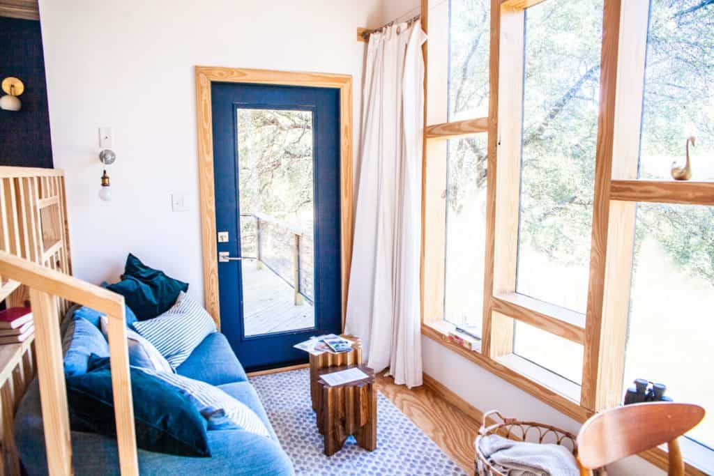 a living room with a blue door and a couch