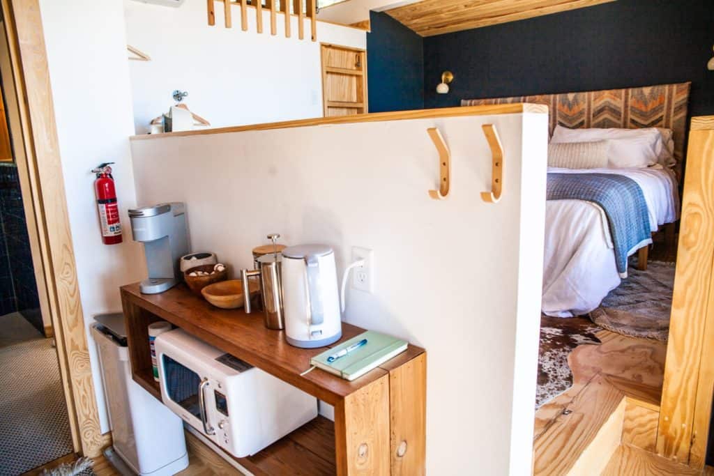 a kitchen with a microwave and coffee maker