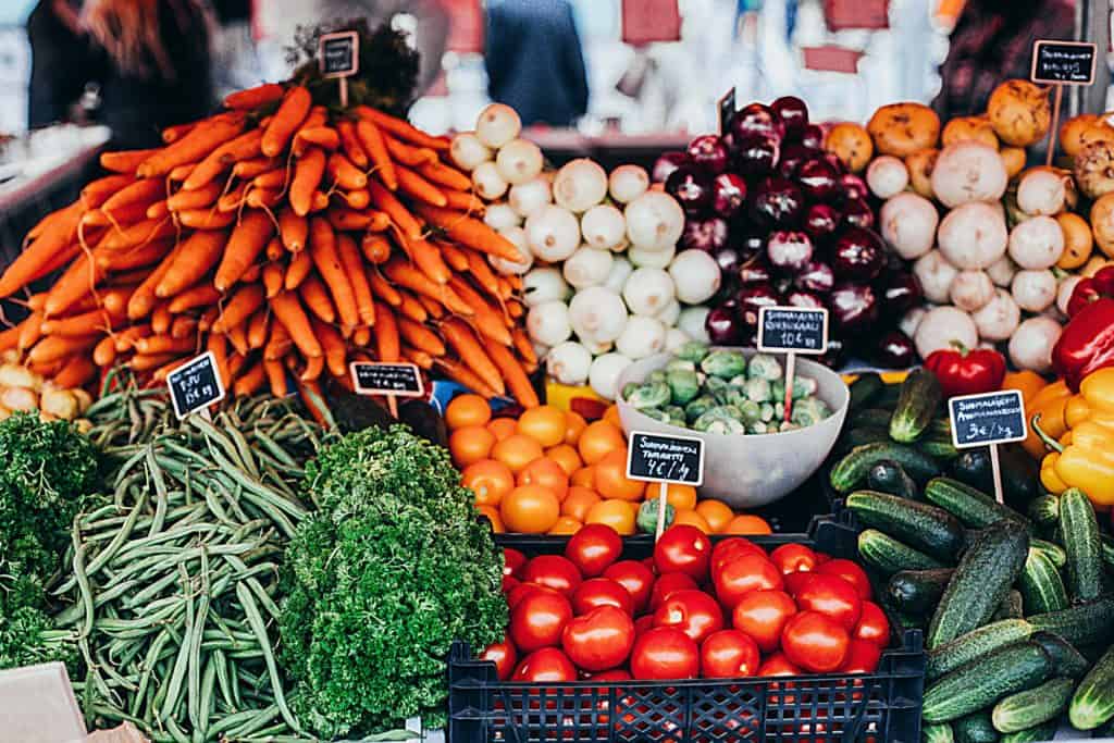 A vibrant farmers' market display featuring a variety of fresh vegetables