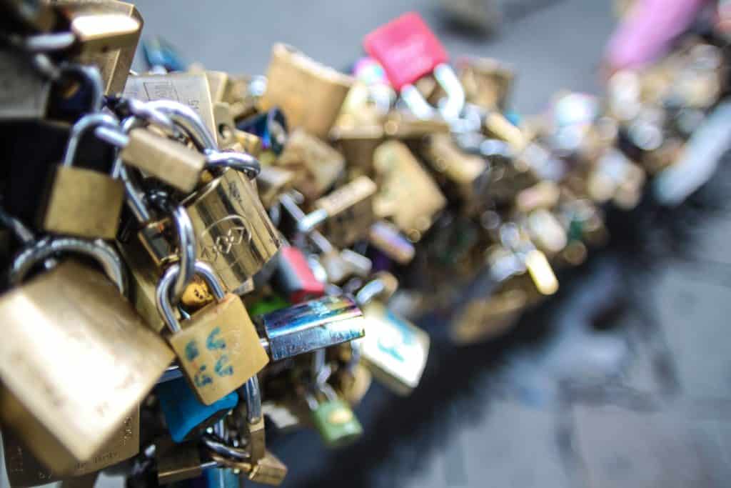 Close-up of numerous love locks attached to a bridge railing