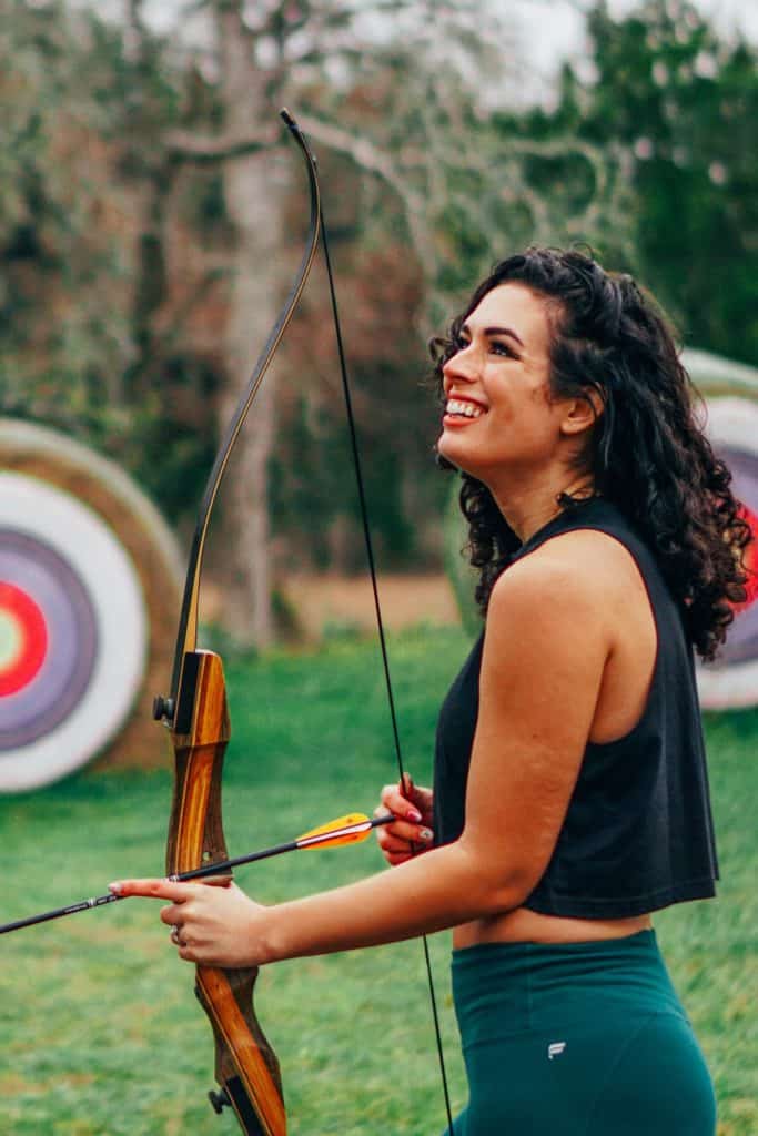 a woman holding a bow and arrow