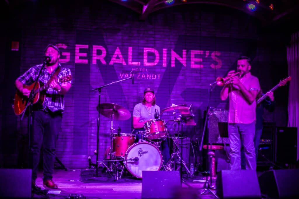 A vibrant live band performs on stage at Geraldine's hotel van zandt