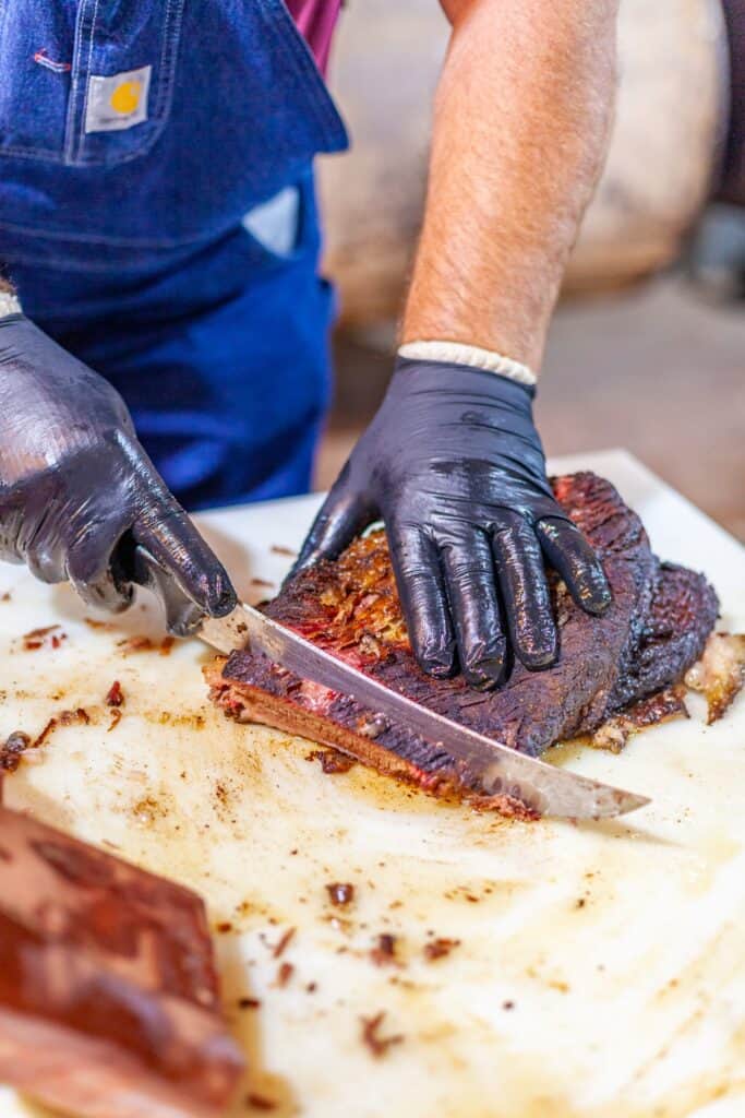 a person cutting meat with a knife