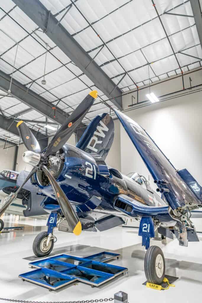 a blue airplane in a hangar