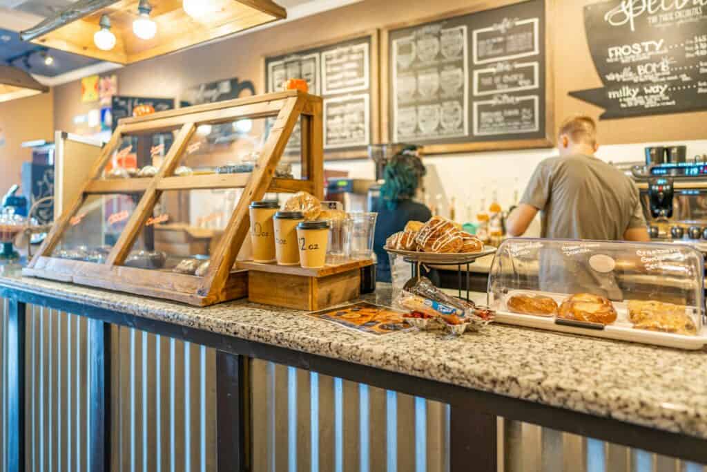 a counter with pastries and coffee