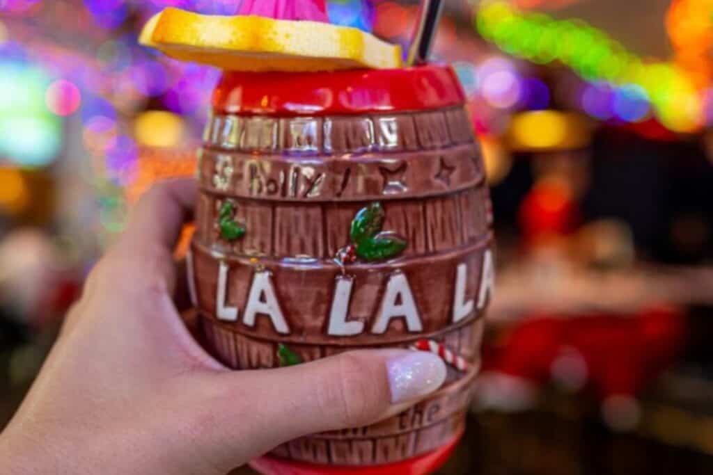 A Christmas cocktail inside a cup that looks like a wooden barrel