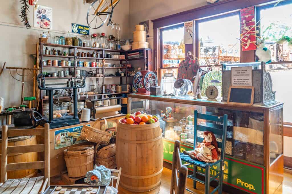 a room with a glass display case and shelves with objects