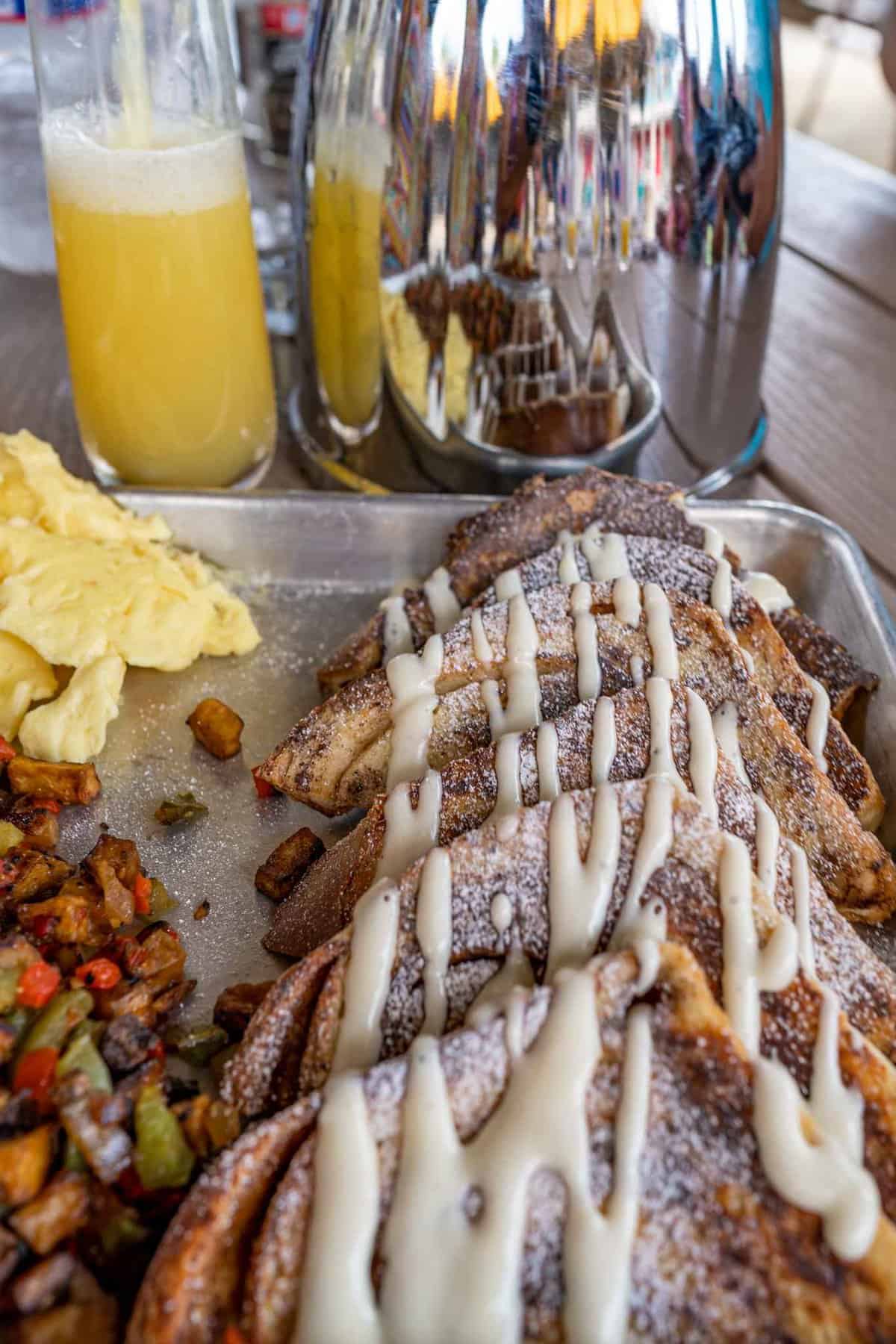 A tray featuring golden French toast drizzled with syrup