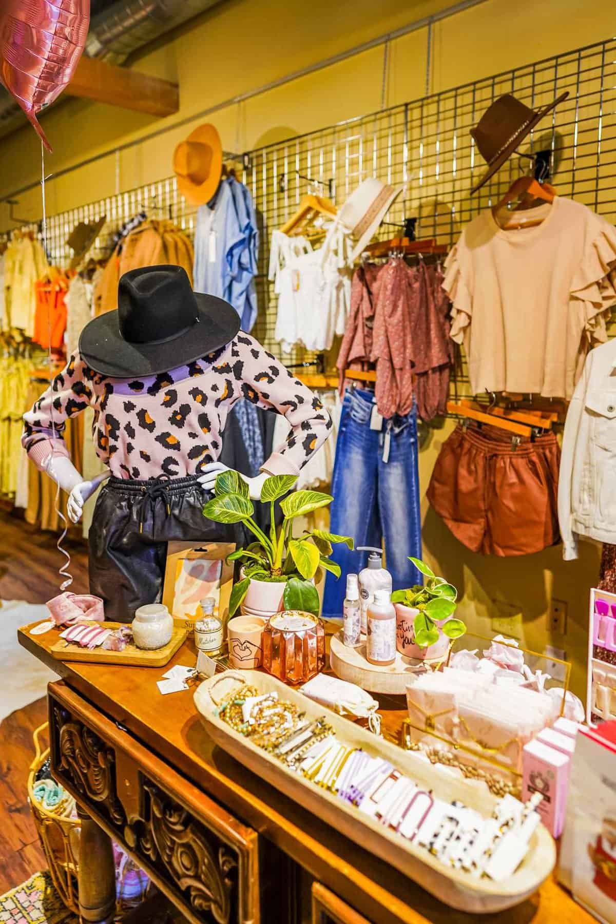 A stylish boutique display featuring a leopard print outfit on a mannequin