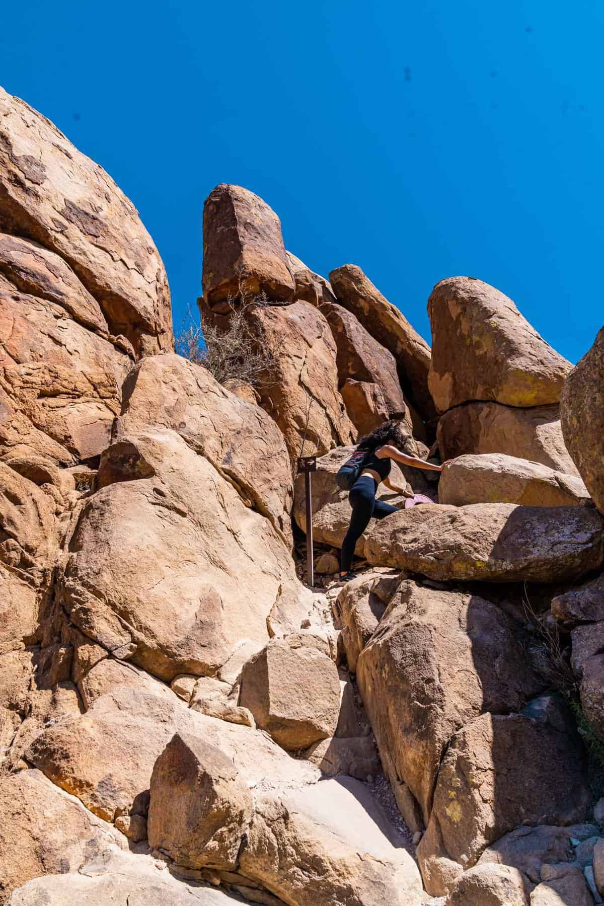 Jessica climbing the boulders on the way to the Balanced Rock formation in Big Bend