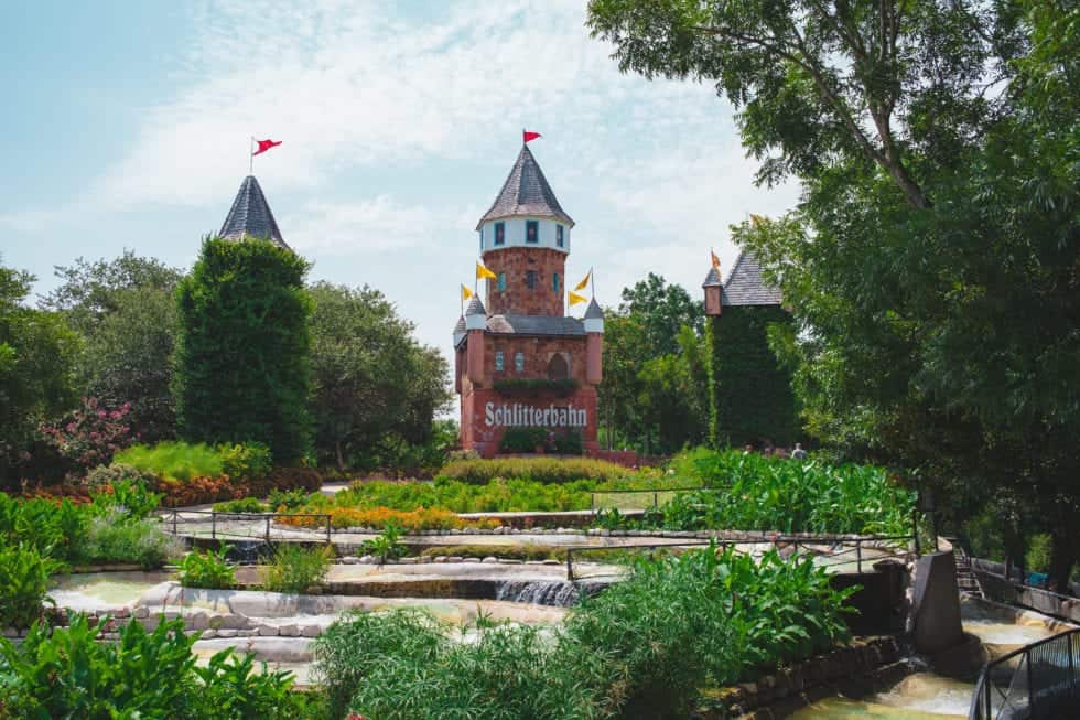 a castle with towers and a fountain