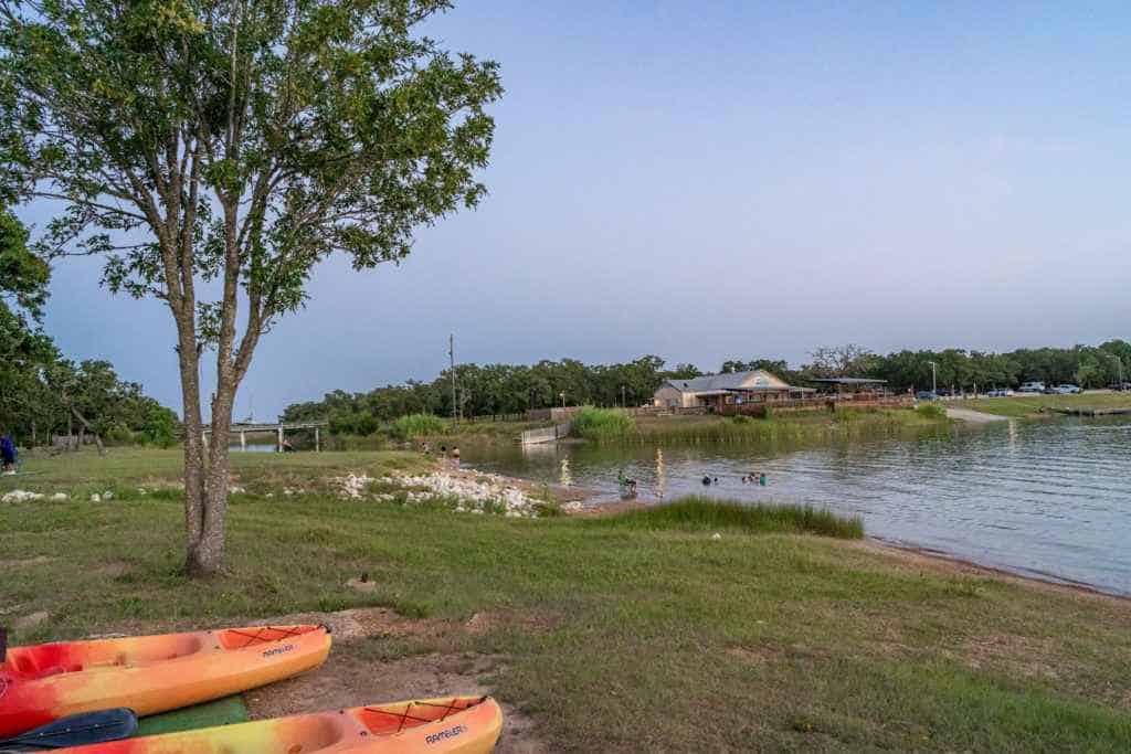 Lake Bryan with kayaks on the shore in Bryan TX Lake Getaway