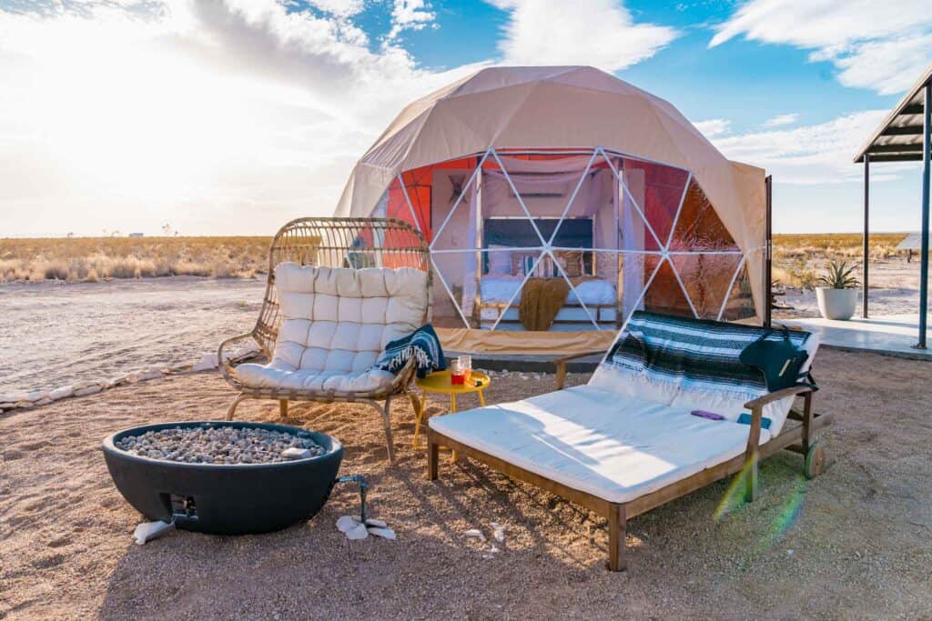 Outdoor seating with firepit outside of glamping bubble near Big Bend