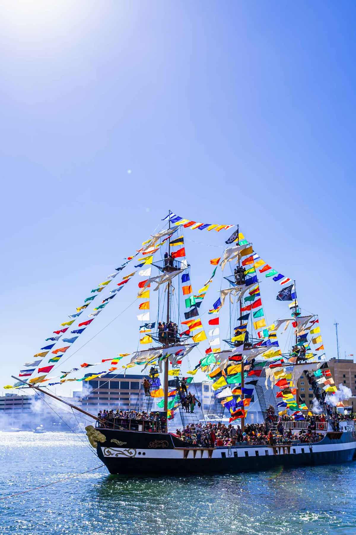 Pirate ship with smoke around its cannons at Gasparilla Pirate Fest Things to Do couples