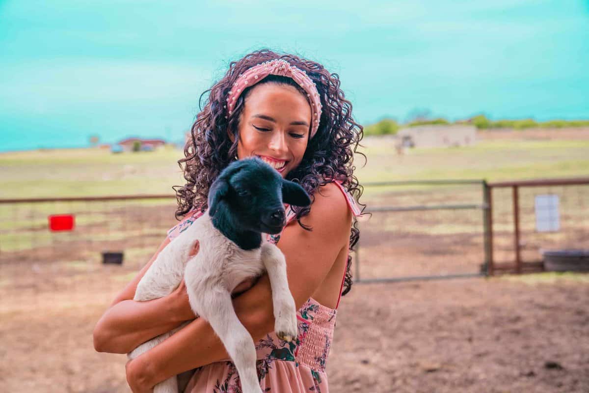 Jessica holding a baby lamb at Laughing Llama Farm near Belton