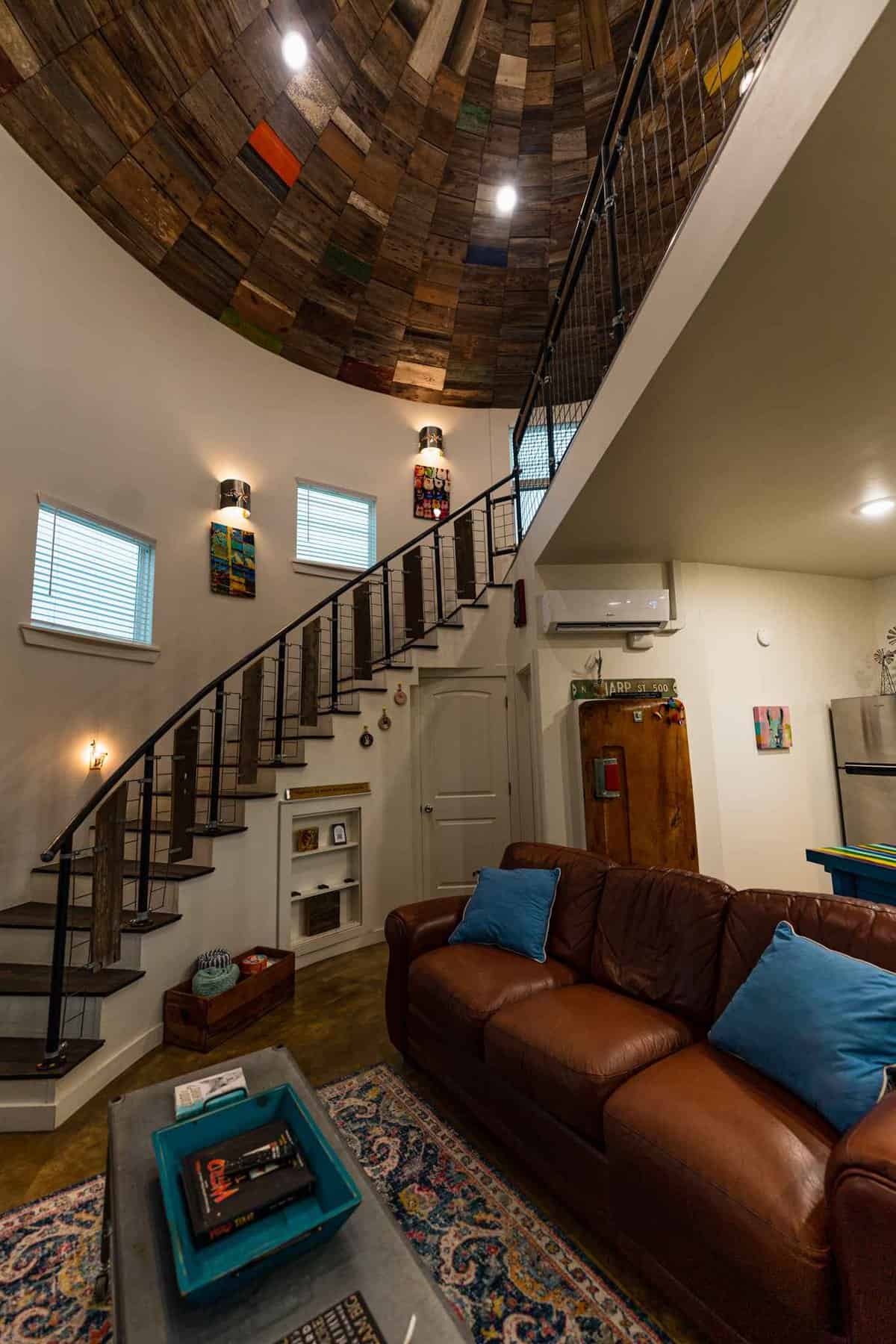 Entry way and staircase leading to living area inside Silo House