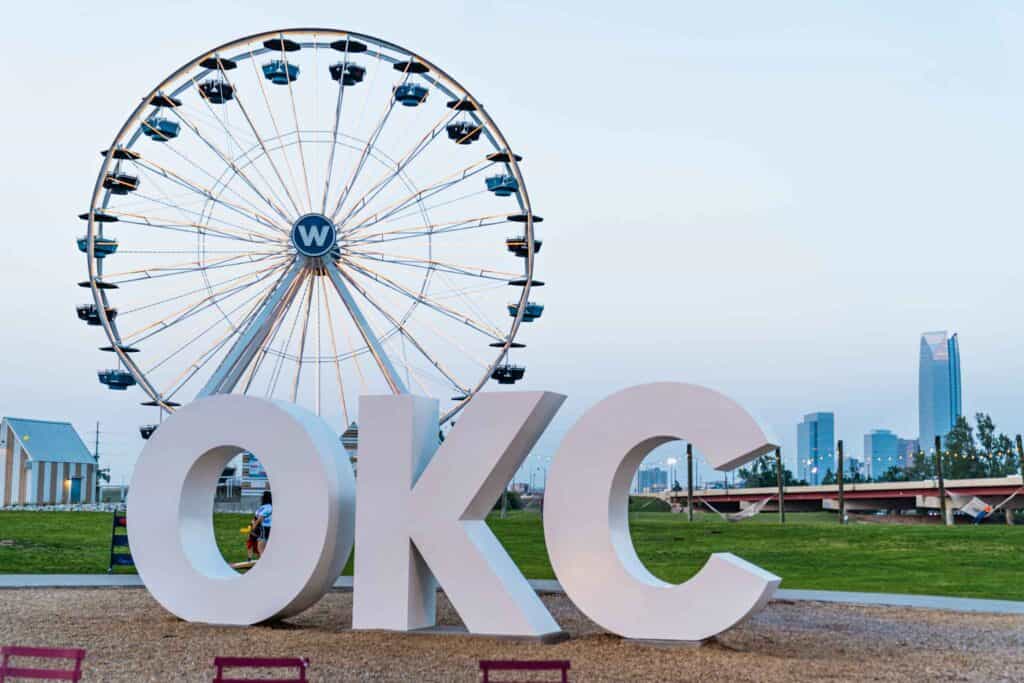 Ferris wheel behind the OKC sign