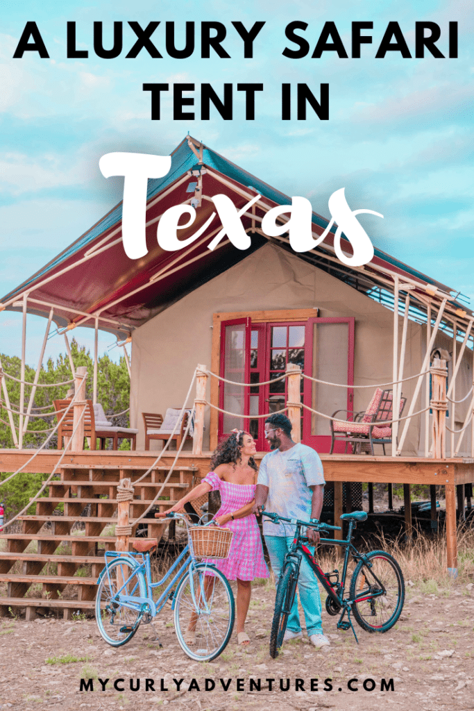 Couple holding a bike with Luxe Tent in the background