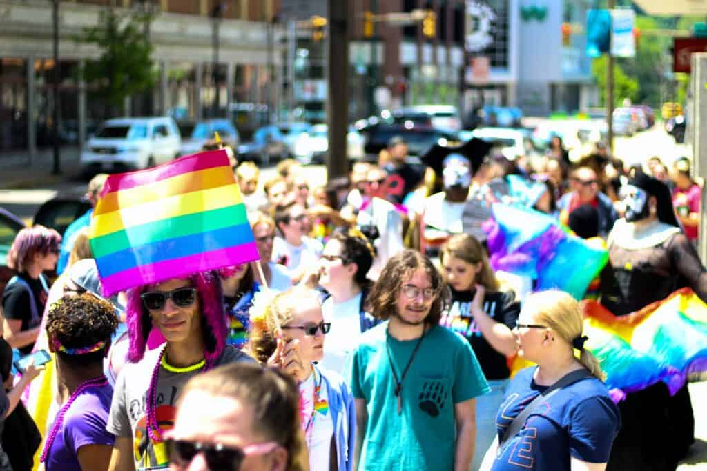 People parading with a Pride flag