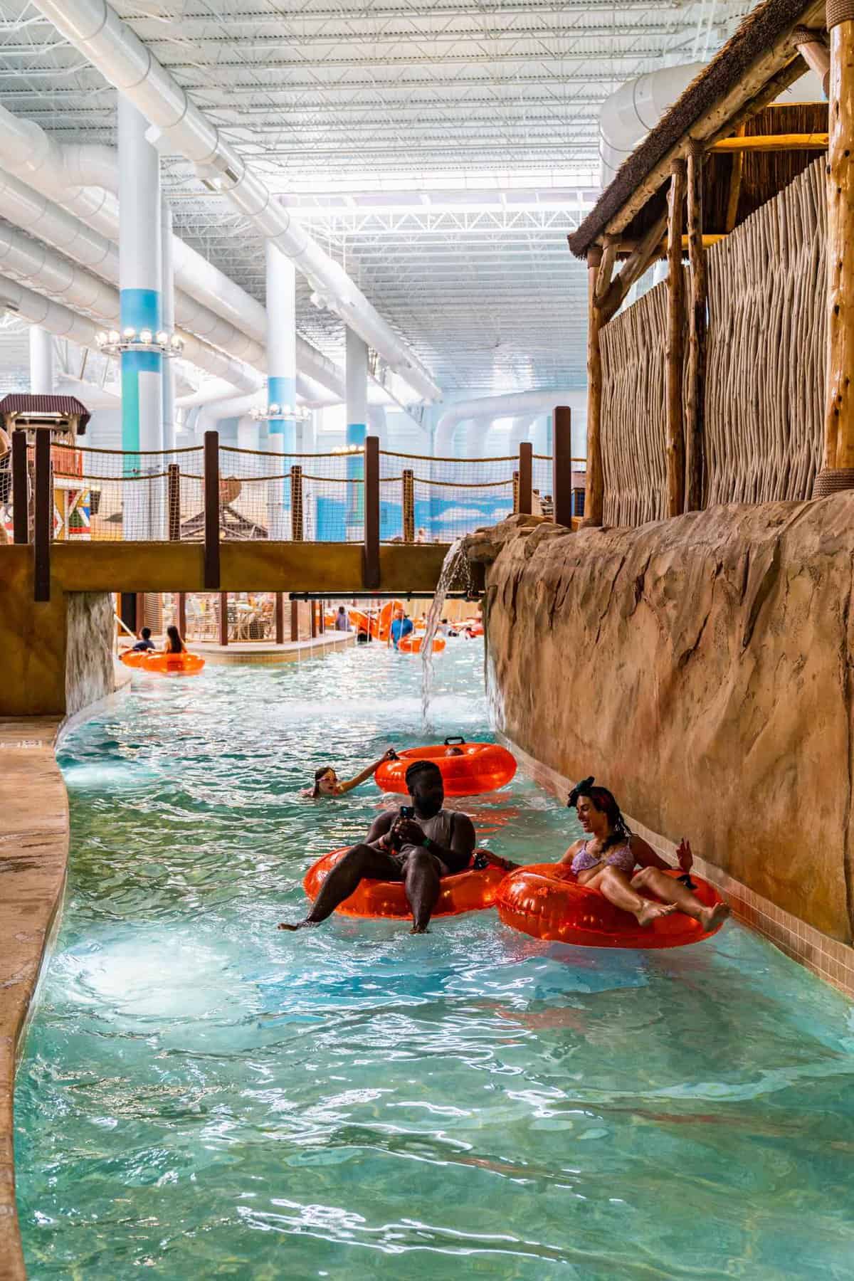 Couple riding a lifebuoy by the pool