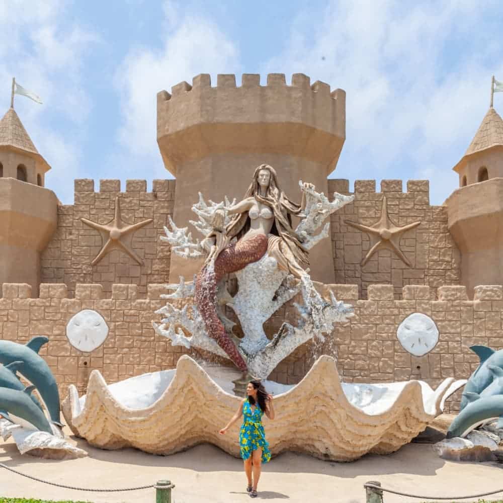 Huge sandcastle with a mermaid inside a huge clam shell